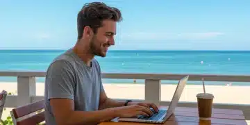 Young adult working remotely on beach, embodying digital nomad freedom