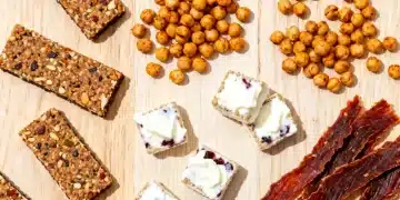 Assortment of high protein low calorie snacks on a wooden table, emphasizing healthy eating.